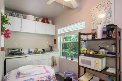 a kitchen with white cabinets and a window at The Wild Rose in Miami