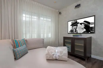 a living room with a couch and a flat screen tv at The Marlin Hotel in Miami Beach