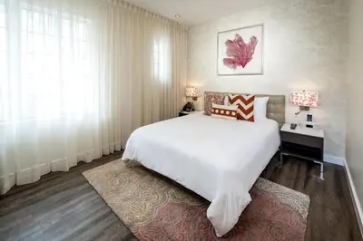 a bedroom with a large white bed and a desk at The Marlin Hotel in Miami Beach