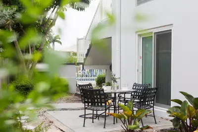 an outdoor patio with a table and chairs at Lovely apartment on the canal with a pool in Fort Lauderdale