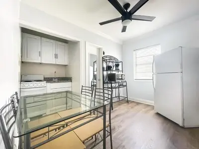 a kitchen with a glass table and a refrigerator at Paradise Oceanfront by HBH in Hollywood