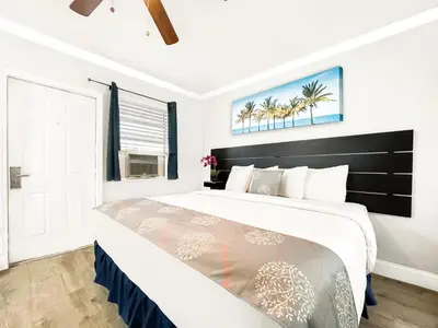 a bedroom with a large bed and a window at Paradise Oceanfront by HBH in Hollywood