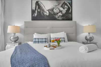 a bed with a tray of food on it with two lamps at Luxury Waterfront Condo In The Urban Oasis At Icon-Brickell Free Spa in Miami