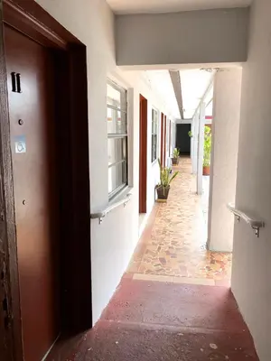 an empty hallway of a building with a door at Ramona Motel in Miami
