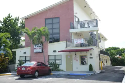 a red car parked in front of a building at Carl's El Padre Motel in Miami