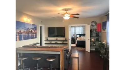 a living room with a ceiling fan and a tv at Modern 2/1 Apt near Midtown and Beaches in Miami