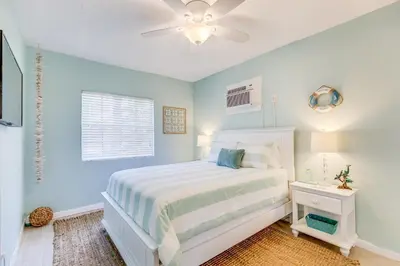 a bedroom with a white bed and a ceiling fan at A Suite Retreat in Miami