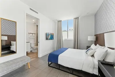 a hotel room with a bed and a bathroom at MILLA South Beach in Miami Beach