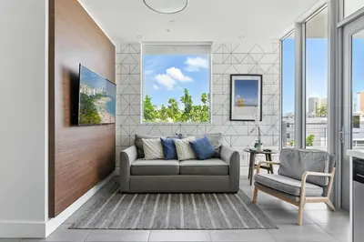 a living room with a couch and a chair at MILLA South Beach in Miami Beach