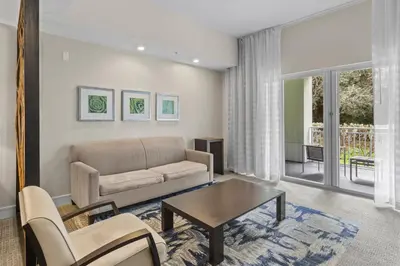 a living room with a couch and a table at Provident Doral At The Blue in Miami
