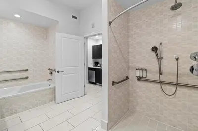 a bathroom with a shower and a tub and a sink at Provident Doral At The Blue in Miami