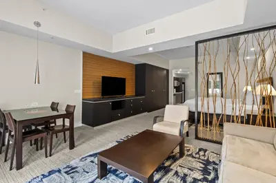 a hotel room with a bed and a living room at Provident Doral At The Blue in Miami