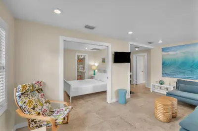 a living room with a couch a chair and a bed at Grove Bay Bungalow - 2/2 Gated Cottage-Walk to Bay in Miami