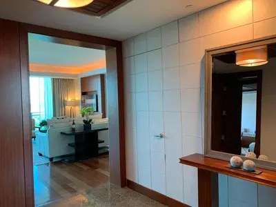 a bathroom with a mirror and a room with a sink at One Bal Harbour Ritz Bal Harbour in Miami Beach