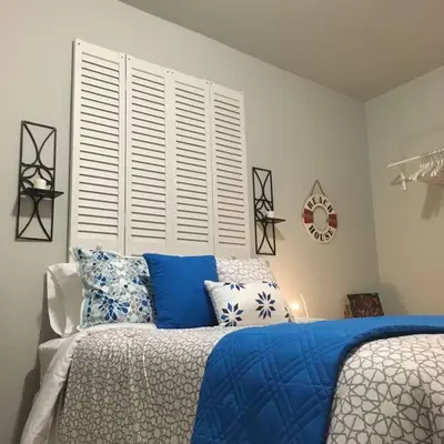 a bedroom with a bed with blue and white pillows at Walk to Restaurants and Shops - 5S in Miami