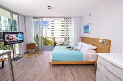 a bedroom with a bed and a tv in a room at 6080 Design Hotel by Eskape Collection in Miami Beach