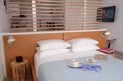 a bedroom with a bed with a laptop on it at 6080 Design Hotel by Eskape Collection in Miami Beach