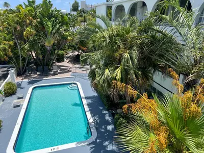 an overhead view of a swimming pool with palm trees at Tropi Rock in Fort Lauderdale