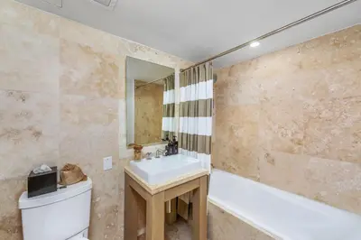 a bathroom with a sink and a tub and a toilet at Oceanview Private Condo at 1 Hotel & Homes -1544 in Miami Beach