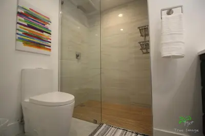 a bathroom with a toilet and a glass shower at Yacht Club at Aventura 2 Bed 2 bath Luxurius Cozy Brand New in Aventura