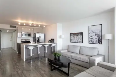 a living room with a couch and a table at 4 BDR Sweeping Bayfront Elegance in Miami