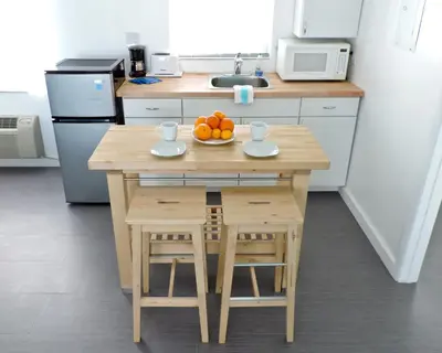 a kitchen with a table with a bowl of fruit on it at Snooze in Fort Lauderdale