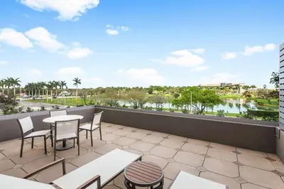 a balcony with tables and chairs and a view of a river at Hilton Miami Dadeland in South Miami