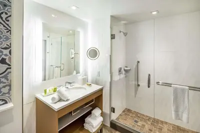 a bathroom with a sink and a shower at Hilton Miami Dadeland in South Miami