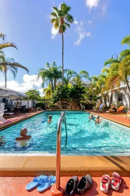 a swimming pool with flip flops and people in it at Richard's Motel in Hollywood