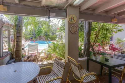 a patio with a table and chairs and a pool at Richard's Motel in Hollywood