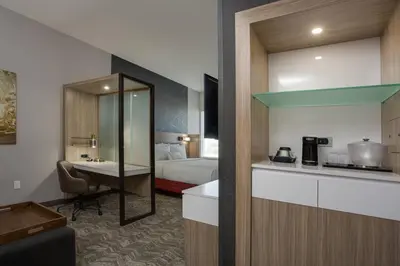 a hotel room with a bed and a kitchen at SpringHill Suites by Marriott Fort Lauderdale Miramar in Miramar