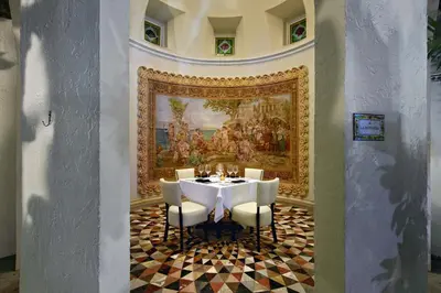 a dining room with a table and a painting on the wall at The Villa Casa Casuarina in Miami Beach