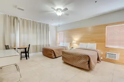 a hotel room with two beds and a table at James Hotel in Miami Beach
