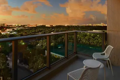 a balcony with two chairs and a view of the city at Courtyard Miami Coconut Grove in Miami