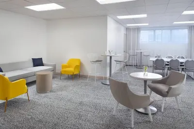 a waiting room with chairs and tables and a couch at Courtyard Miami Coconut Grove in Miami