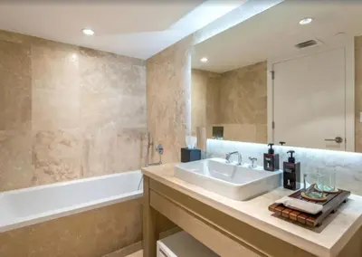 a bathroom with a sink and a bath tub and a tubermott at 1 Hotel & Homes Miami Beach Oceanfront Residence Suites By Joe Semary in Miami Beach