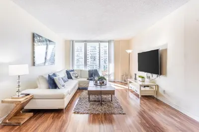 a living room with a white couch and a tv at Luxury Miami Condos in Miami Beach