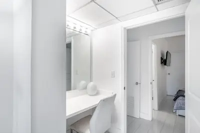 a white bathroom with a sink and a mirror at Luxury Miami Condos in Miami Beach
