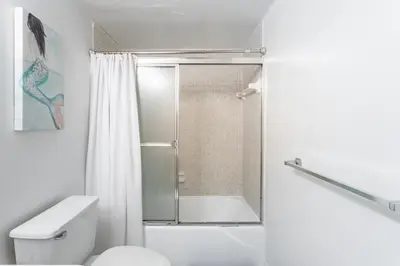 a white bathroom with a shower and a toilet at Luxury Miami Condos in Miami Beach