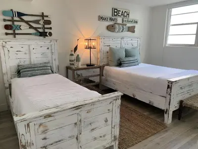 a bedroom with two beds and a table with a lamp at Direct Ocean View Condo at Tides of Hollywood - 7N in Hollywood