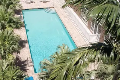 an overhead view of a swimming pool with palm trees at Hampton Inn Hallandale Beach-Aventura in Hollywood