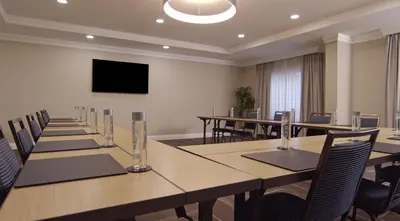a conference room with tables and chairs and a flat screen tv at Hampton Inn Hallandale Beach-Aventura in Hollywood