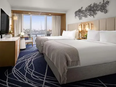 a hotel room with two beds and a balcony at Hilton Fort Lauderdale Marina in Fort Lauderdale