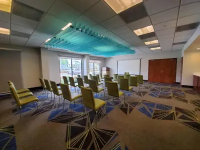 a conference room with chairs and a whiteboard in a building at Holiday Inn Express & Suites Miami - Hialeah by IHG in Hialeah