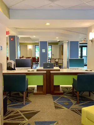 an office with a desk and chairs in a room at Holiday Inn Express & Suites Miami - Hialeah by IHG in Hialeah
