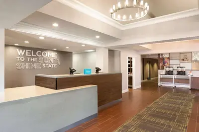 a lobby with a welcome to the sun shine store at Hampton Inn & Suites Fort Lauderdale Airport in Hollywood