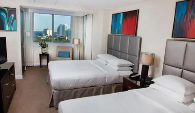 a hotel room with two beds and a television at GALLERY One - A DoubleTree Suites by Hilton Hotel in Fort Lauderdale