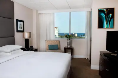 a hotel room with a bed and a window at GALLERY One - A DoubleTree Suites by Hilton Hotel in Fort Lauderdale