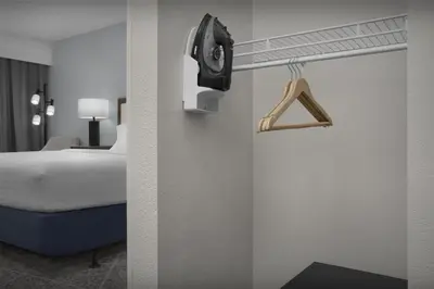 a hotel room with a bed and a hanger at Hampton Inn Fort Lauderdale Downtown Las Olas Area in Fort Lauderdale