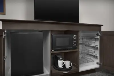 a entertainment center with a tv and a entertainment center at Hampton Inn Fort Lauderdale Downtown Las Olas Area in Fort Lauderdale